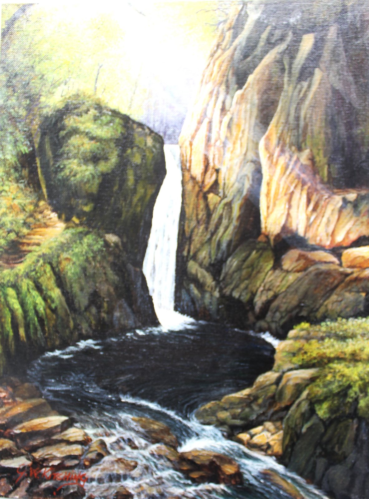 Stanley Ghyll Eskdale: A narrow waterfall drops between mossy boulders and tall rock walls into a dark pool that tumbles away over stones.